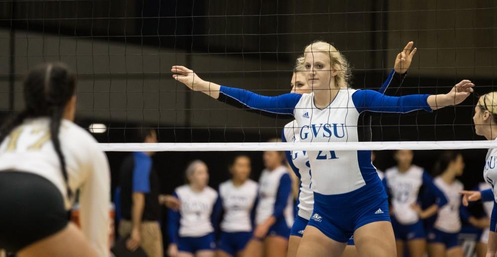 GVL/Kevin Sielaff - Staci Brower (21) sets herself in front of the net before a Grand Valley serve. The Lakers sweep the Cavaliers of Walsh University Saturday, Sept. 24, 2016 in Allendale.