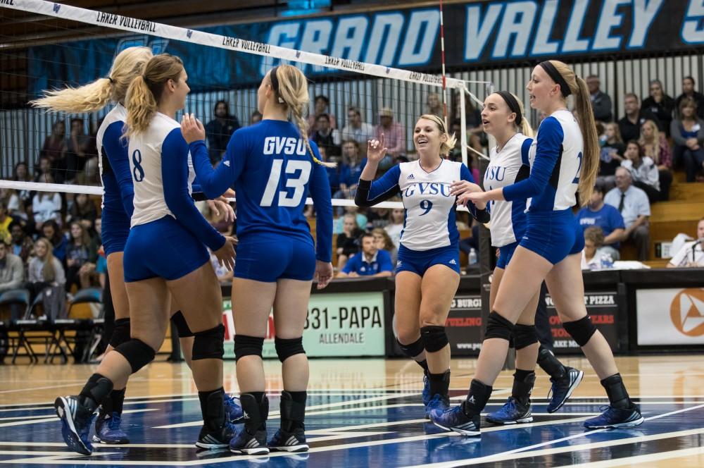 GVL/Kevin Sielaff - Katie Olson (9) and company celebrate a Grand Valley point. The Lakers sweep the Cavaliers of Walsh University Saturday, Sept. 24, 2016 in Allendale.