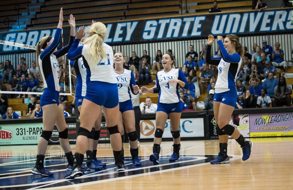 GVL/Kevin Sielaff - Kaylene Norris (4) and company celebrate a Grand Valley point. The Lakers sweep the Cavaliers of Walsh University Saturday, Sept. 24, 2016 in Allendale.