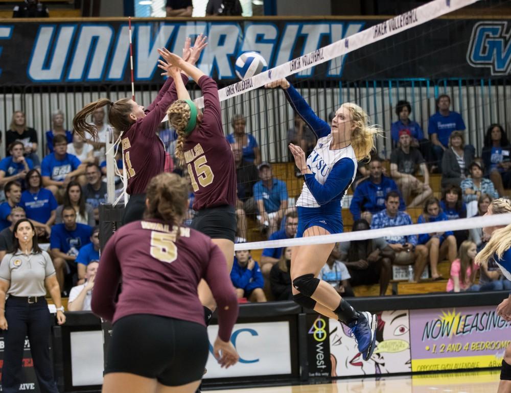 GVL/Kevin Sielaff - Staci Brower (21) spikes the ball. The Lakers sweep the Cavaliers of Walsh University Saturday, Sept. 24, 2016 in Allendale.