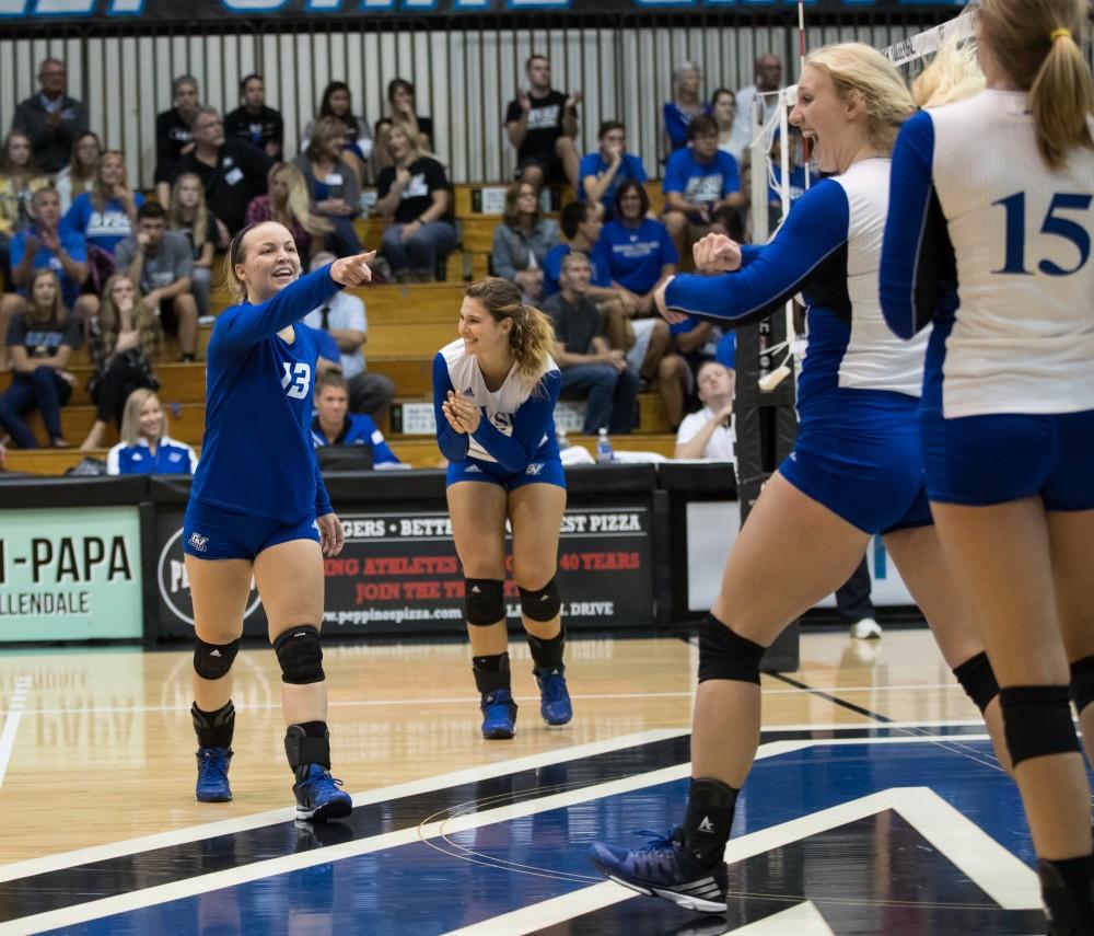 GVL/Kevin Sielaff - Amanda Glaza (13) and Staci Brower (21) celebrate a Grand Valley point. The Lakers sweep the Cavaliers of Walsh University Saturday, Sept. 24, 2016 in Allendale.