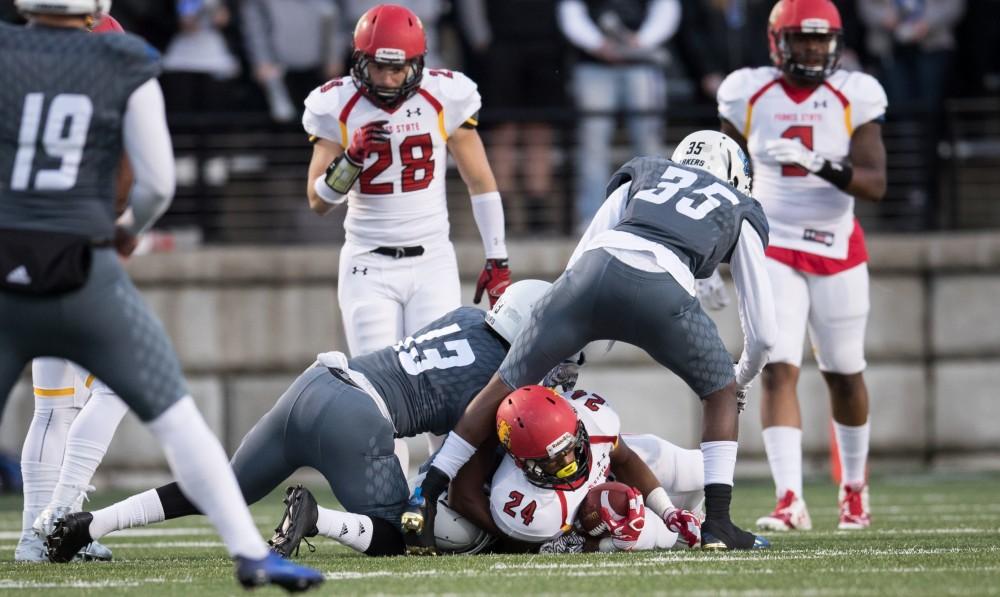 GVL/Kevin Sielaff - Jahaan Brown (24) of Ferris State is taken down by Grand Valley's DaMario Johnson (35) after a short gain. The Lakers defeat the Bulldogs of Ferris State University Saturday, Oct. 8, 2016 with a final score of 35-23 in Allendale. 