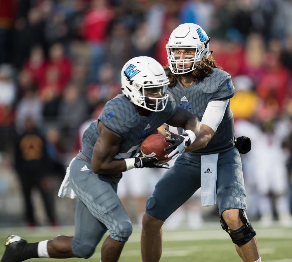 GVL/Kevin Sielaff - Bart Williams (6) hands the ball off to Marty Carter (21). The Lakers defeat the Bulldogs of Ferris State University Saturday, Oct. 8, 2016 with a final score of 35-23 in Allendale. 