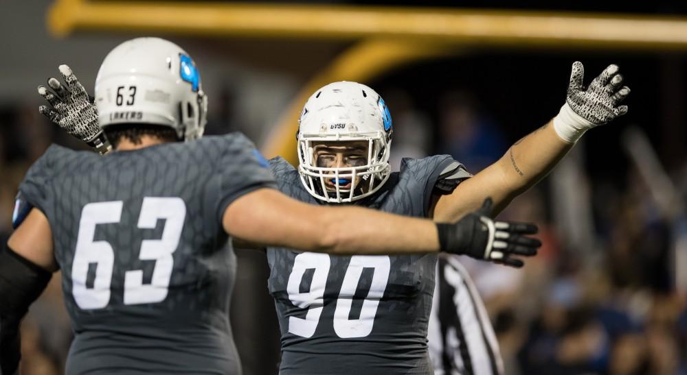 GVL/Kevin Sielaff - Mark Rosenquist (90) and Ben Walling (63) celebrate a Grand Valley fumble recovery in Ferris' end zone for a Laker touchdown. The Lakers defeat the Bulldogs of Ferris State University Saturday, Oct. 8, 2016 with a final score of 35-23 in Allendale. 