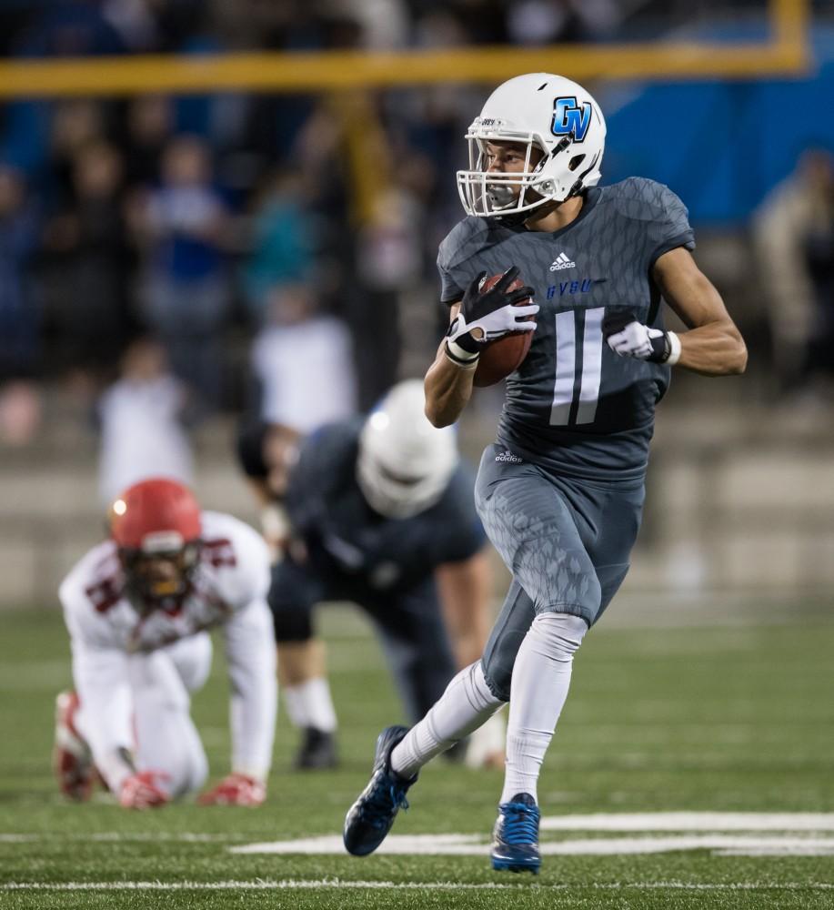 GVL/Kevin Sielaff - Nick Dodson (11) protects the ball as he moves up field. The Lakers defeat the Bulldogs of Ferris State University Saturday, Oct. 8, 2016 with a final score of 35-23 in Allendale. 