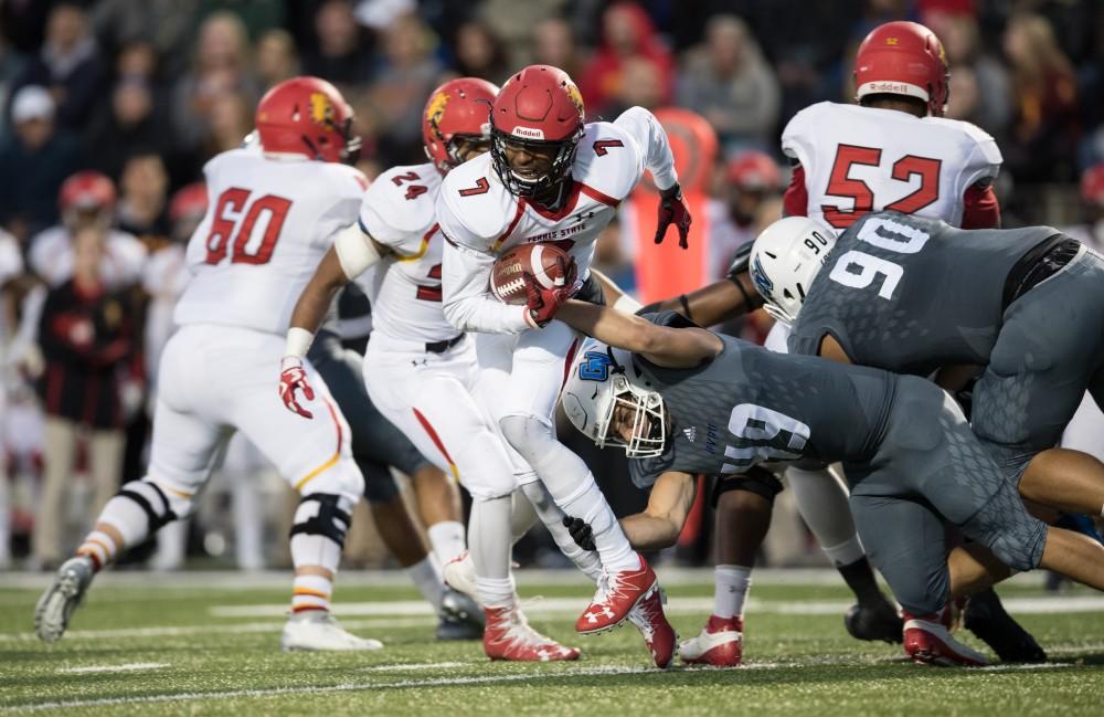 GVL/Kevin Sielaff - Reggie Bell (7) of Ferris is brought down by Collin Schlosser (49) for a loss. The Lakers square off against the Bulldogs of Ferris State University Saturday, Oct. 8, 2016. 