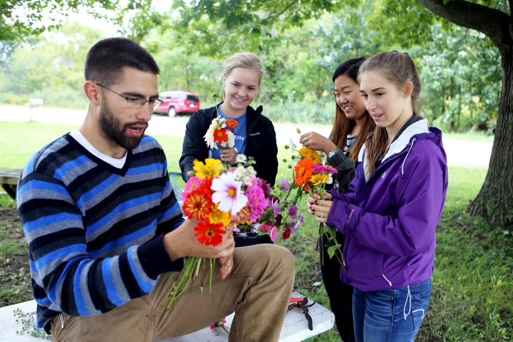 GVL / Emily Frye    
Youssef Darwich (far left) assists some Grand Valley student volunteers at the GVSU Sustainability Farm on Friday Sept. 30, 2016.