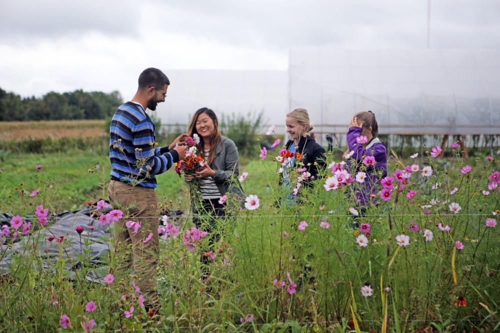 GVL / Emily Frye    
Youssef Darwich (far left) assists some Grand Valley student volunteers at the GVSU Sustainability Farm on Friday Sept. 30, 2016.