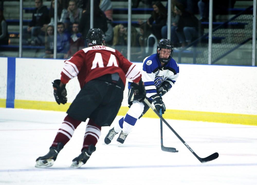 GVL / Emily Frye
Reede Burnett takes the puck down the rink on Friday Oct. 7, 2016 against Rochester College.