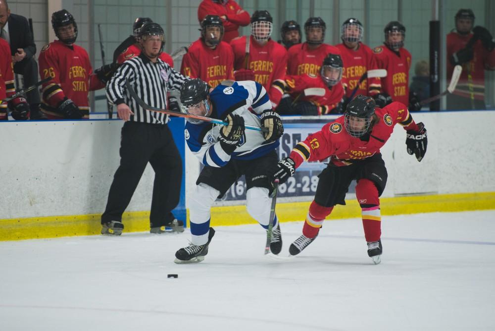 GVL / Luke Holmes - Zach Resnick (6) protects the puck from the defender. GVSU Men’s D2 Hockey defeated Ferris State University with a score of 8-1 on Saturday, Oct. 16, 2016.