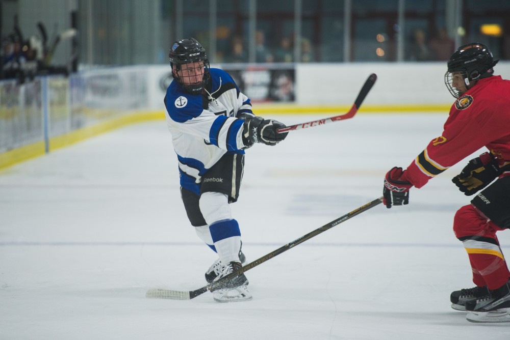 GVL / Luke Holmes - Reede Burnett (12) takes a shot on goal. GVSU Men’s D2 Hockey defeated Ferris State University with a score of 8-1 on Saturday, Oct. 16, 2016.