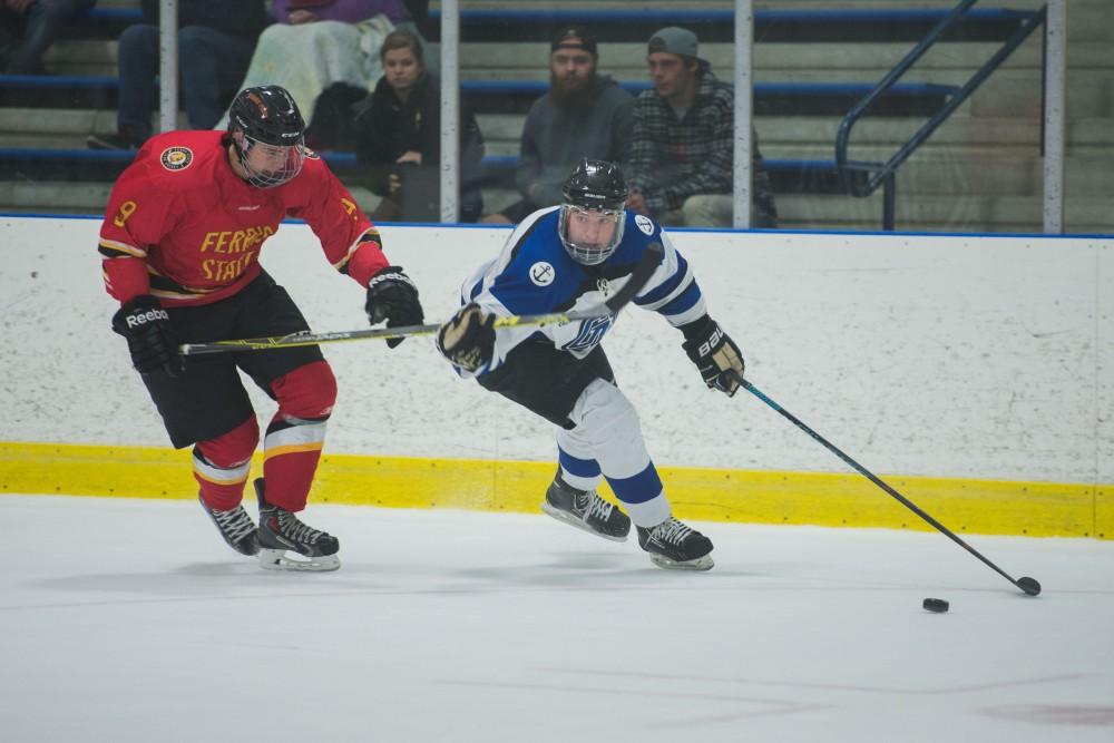 GVL / Luke Holmes - Zach Resnick (6) protects the puck from the defender. GVSU Men’s D2 Hockey defeated Ferris State University with a score of 8-1 on Saturday, Oct. 16, 2016.