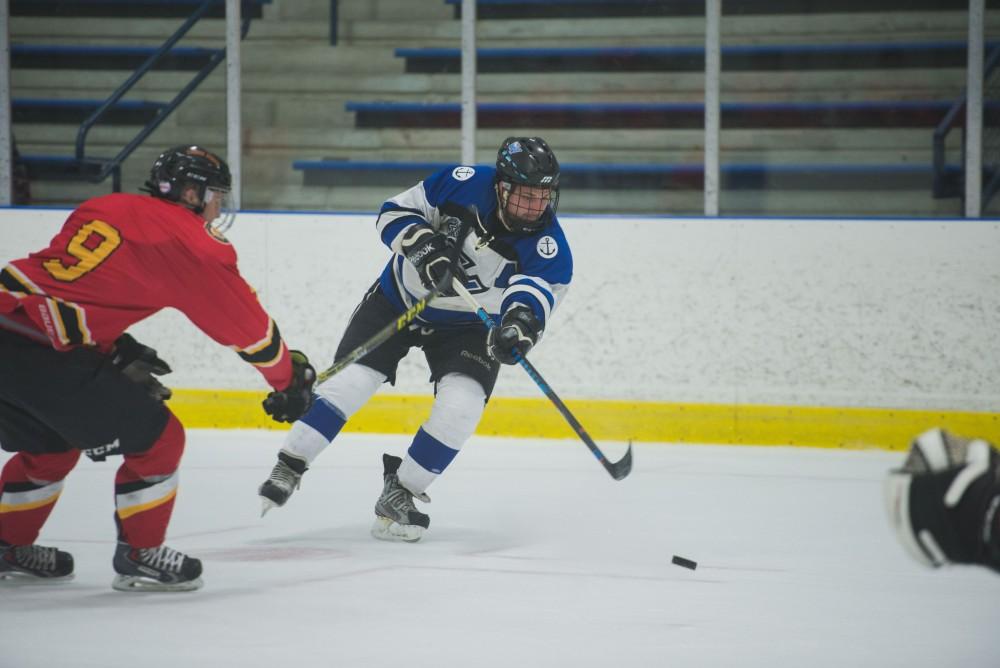 GVL / Luke Holmes - Alex Ostrowski (23) takes a shot on goal. GVSU Men’s D2 Hockey defeated Ferris State University with a score of 8-1 on Saturday, Oct. 16, 2016.