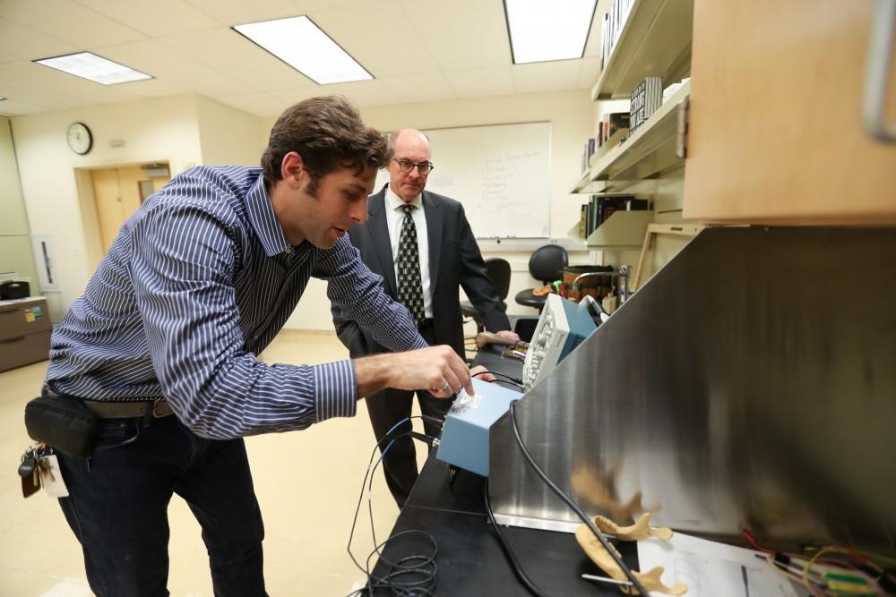 GVL/Kevin Sielaff - Members of the aMDI team Kevin Weaver (right) and Brent Nowak (left) demonstrate an orthoforge device inside of the Cook-DeVos Center for Health Sciences Wednesday, Oct. 26, 2016.  