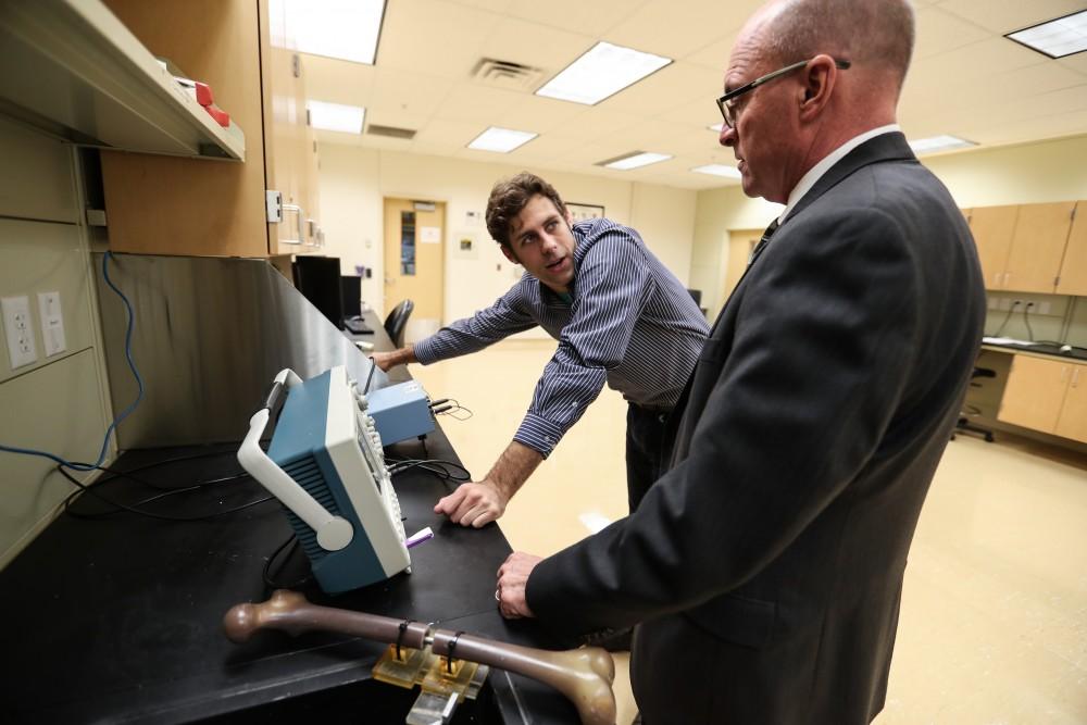 GVL/Kevin Sielaff - Members of the aMDI team Kevin Weaver (right) and Brent Nowak (left) demonstrate an orthoforge device inside of the Cook-DeVos Center for Health Sciences Wednesday, Oct. 26, 2016.  