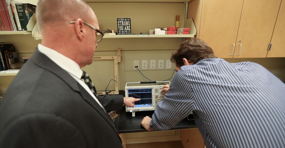 GVL/Kevin Sielaff - Members of the aMDI team Kevin Weaver (right) and Brent Nowak (left) demonstrate an orthoforge device inside of the Cook-DeVos Center for Health Sciences Wednesday, Oct. 26, 2016.  