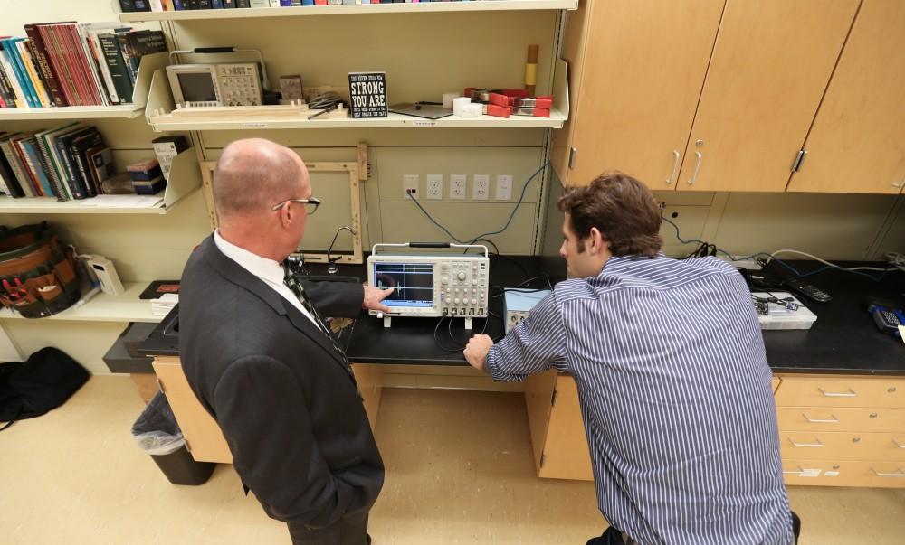 GVL/Kevin Sielaff - Members of the aMDI team Kevin Weaver (right) and Brent Nowak (left) demonstrate an orthoforge device inside of the Cook-DeVos Center for Health Sciences Wednesday, Oct. 26, 2016.  