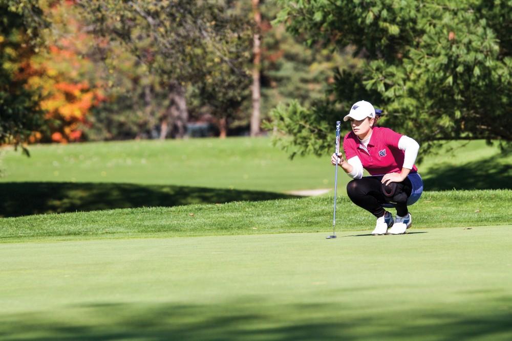 GVL / Sara Carte - Samantha Moss lines up her putt during the Davenport Invitational at the Blythefield Country Club on Monday, Oct. 26, 2015. 