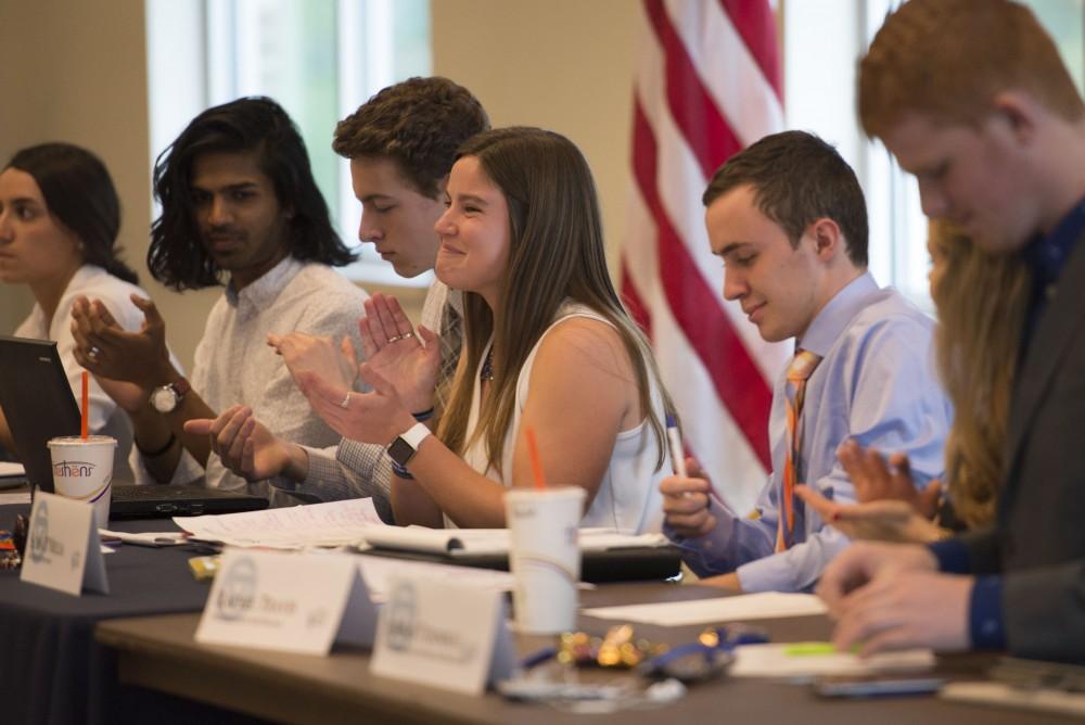 GVL / Luke Holmes - Student Senate members clap after Keri Becker finishes her speech in the Pere Marquette room on Thursday, Oct. 6, 2016. 