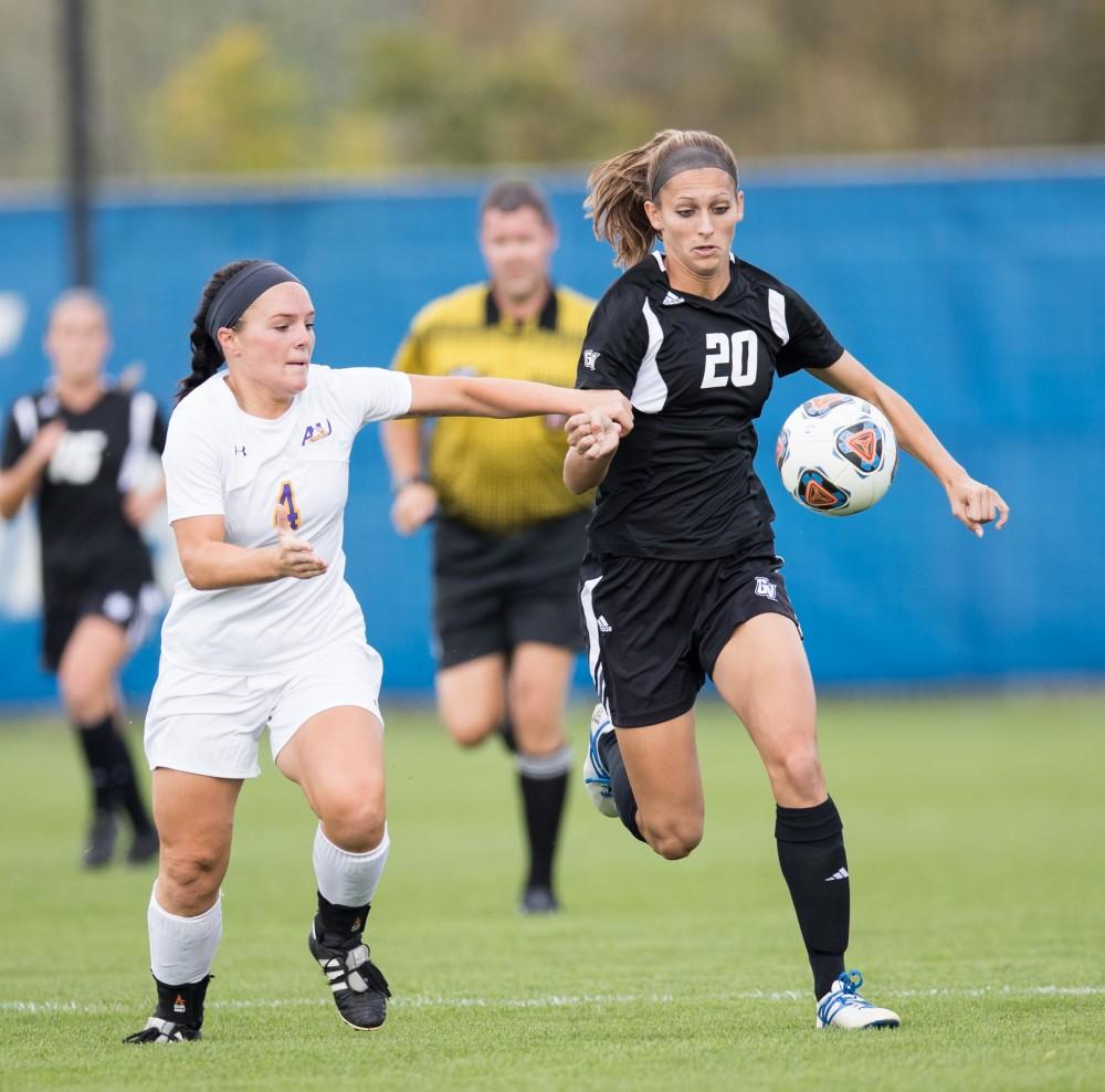 GVL/Kevin Sielaff - Gabriella Mencotti (20) handles the ball as she pushes up field. The Lakers square off against the Eagles of Ashland University Sunday, Oct. 2, 2016 and win with a final score of 5-0 in Allendale.