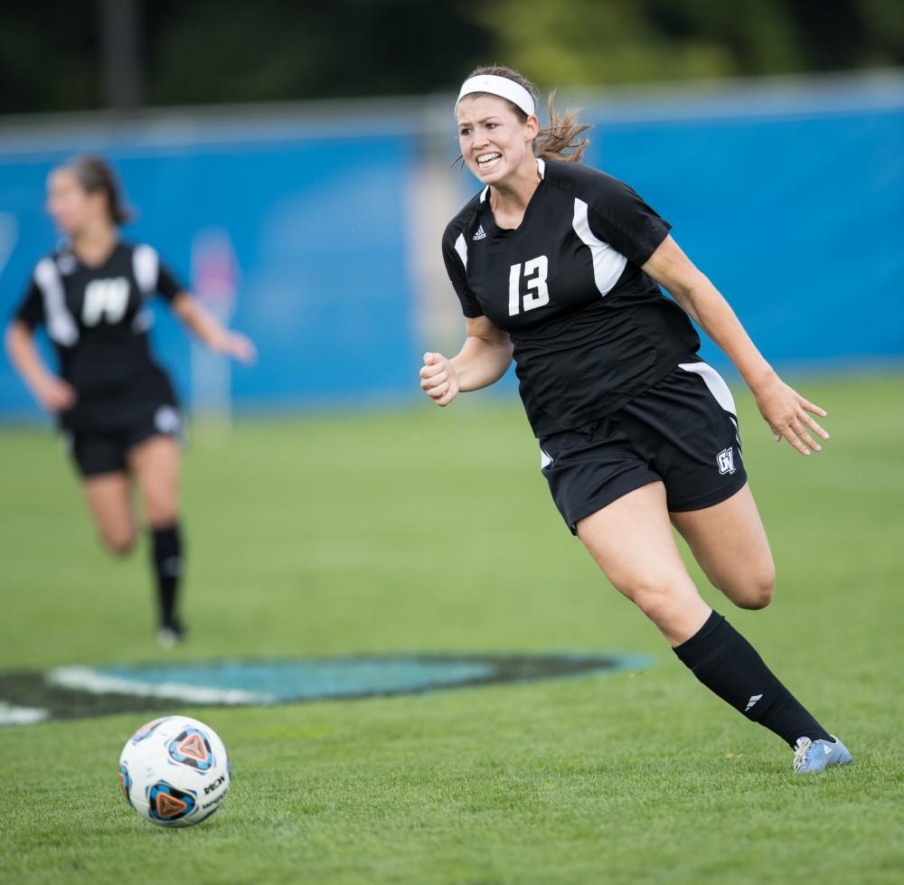 GVL/Kevin Sielaff - Marti Corby (13) sets up and tries a shot on goal. The Lakers square off against the Eagles of Ashland University Sunday, Oct. 2, 2016 and win with a final score of 5-0 in Allendale.