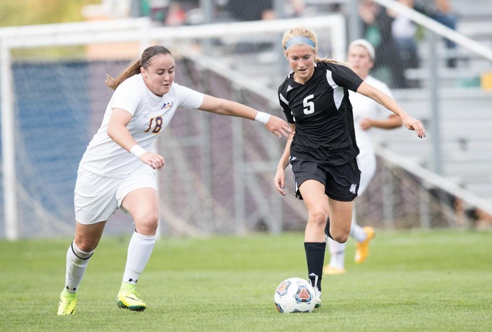 GVL/Kevin Sielaff - Kendra Stauffer (5) moves the ball in front of the Eagles' net. The Lakers square off against the Eagles of Ashland University Sunday, Oct. 2, 2016 and win with a final score of 5-0 in Allendale.