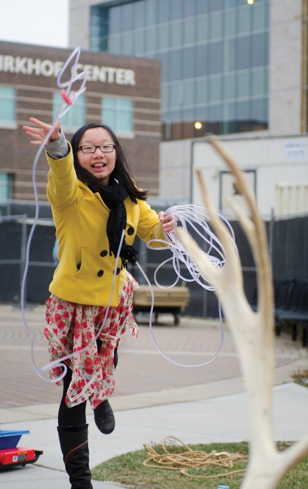 GVL/Archive - Xinyi Ou tries her hand at the reindeer ring toss at the first annual GVSU Arctic Games on Friday, Nov. 30, 2012 outside of Grand Valleys Kirkhof Center.