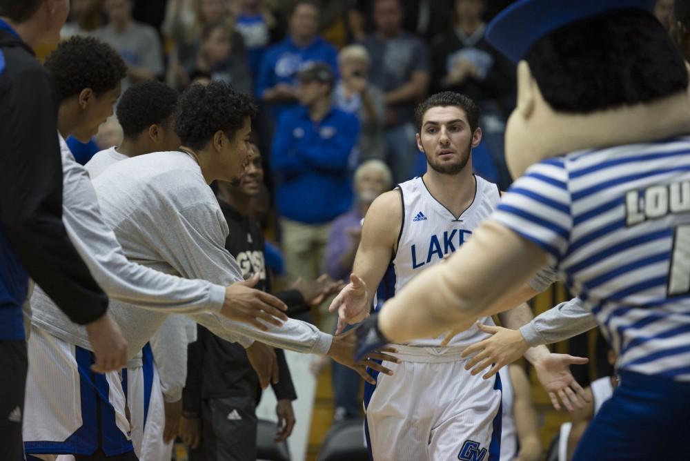 GVL / Luke Holmes - Zach West (11) runs onto the court as the starting lineup is announced. GVSU defeated Trinity Christian on Friday, Nov. 18, 2016. 