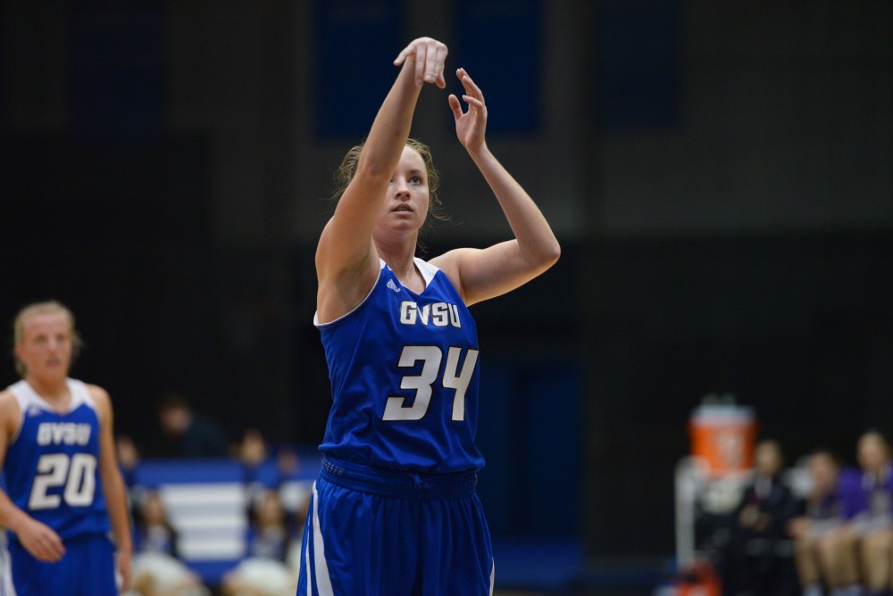 GVL / Luke Holmes - Drake Baar (21) runs onto the court as the starting lineup is announced. GVSU defeated Trinity Christian on Friday, Nov. 18, 2016. 