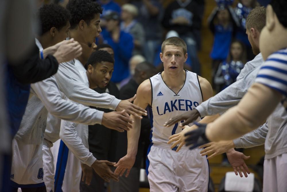 GVL / Luke Holmes - Luke Ryskamp (23) runs onto the court as the starting lineup is announced. GVSU defeated Trinity Christian on Friday, Nov. 18, 2016. 