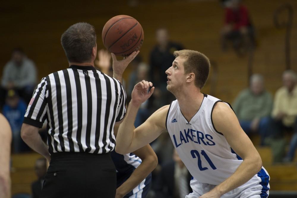 GVL / Luke Holmes - Drake Baar (21) gets ready for the jump ball. GVSU defeated Trinity Christian on Friday, Nov. 18, 2016. 