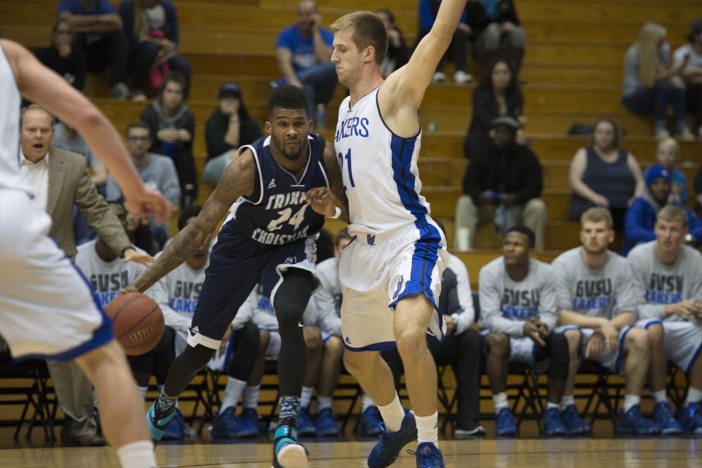 GVL / Luke Holmes - Drake Baar (21) plays tight defense. GVSU defeated Trinity Christian on Friday, Nov. 18, 2016. 