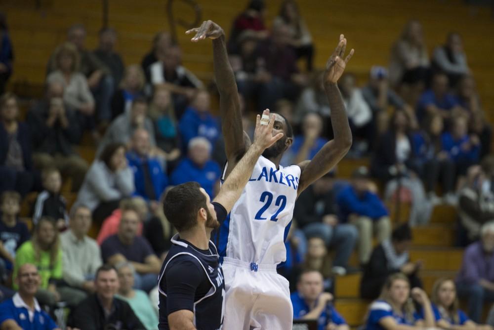 GVL / Luke Holmes - Juwan Starks (22) follows takes a shot with a defender in his face. GVSU defeated Trinity Christian on Friday, Nov. 18, 2016. 