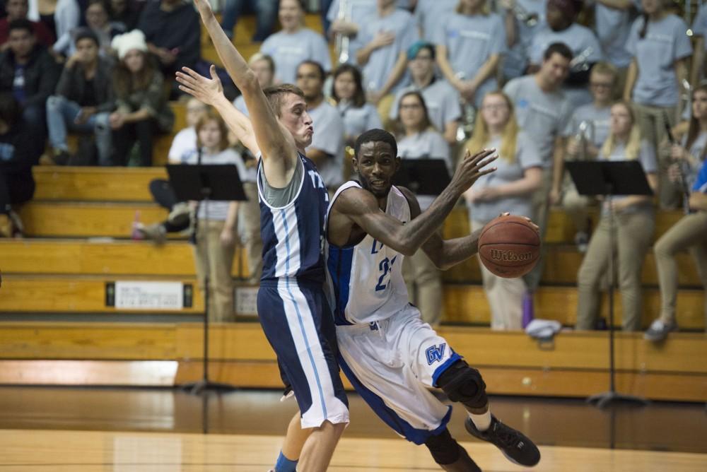 GVL / Luke Holmes - Juwan Starks (22) dribbles around a defender. GVSU defeated Trinity Christian on Friday, Nov. 18, 2016. 