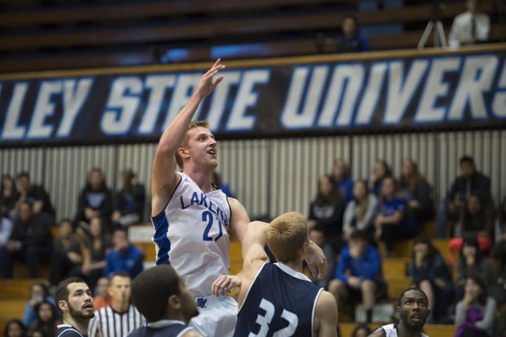 GVL / Luke Holmes - Drake Baar (21) takes the shot from the post. GVSU defeated Trinity Christian on Friday, Nov. 18, 2016. 