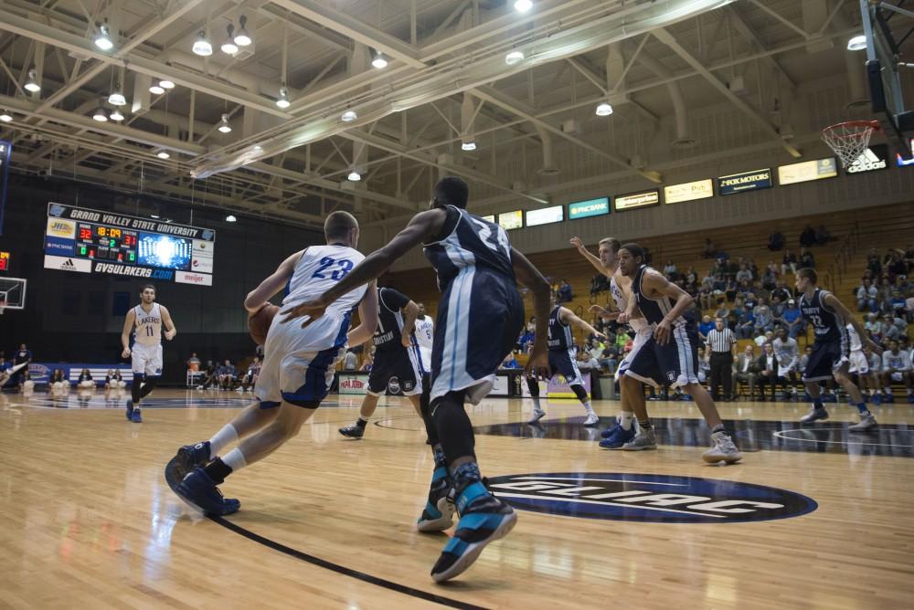 GVL / Luke Holmes - Luke Ryskamp (23) drives to the hole from outside. GVSU defeated Trinity Christian on Friday, Nov. 18, 2016. 