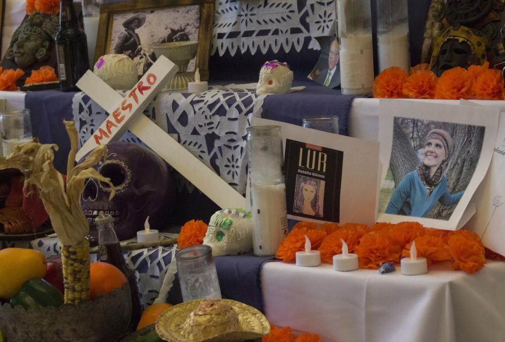 GVL/Mackenzie Bush - GVSU students celebrate Day of the Dead with LAS, Latin American, and Latino Studies by placing pictures of loved ones on an alter. The alter, built by artist Roli Mancera, was set up in Neimeyer the week of Nov. 1, 2016.