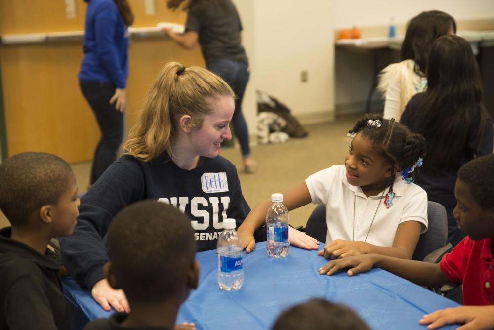 GVL / Luke Holmes - Beth Hopkins plays a game with kids from Dickinson Elementary School.