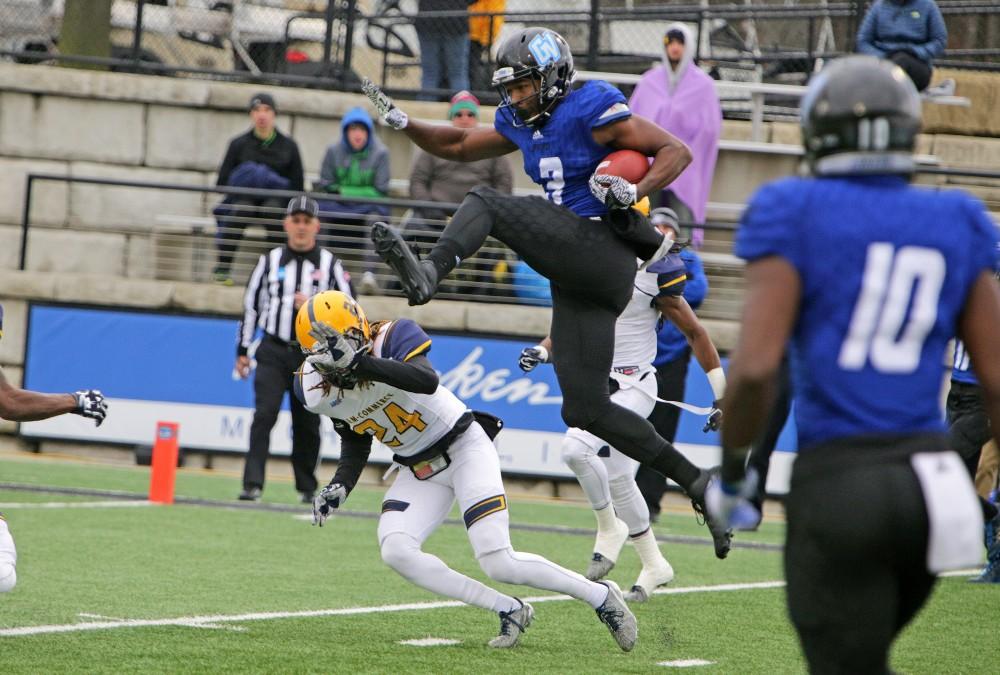 GVL / Emily Frye Brandon Bean hurdles over the opposing team to make the touchdown during the playoff game against Texas A&M Commerce on Saturday Nov. 26, 2016