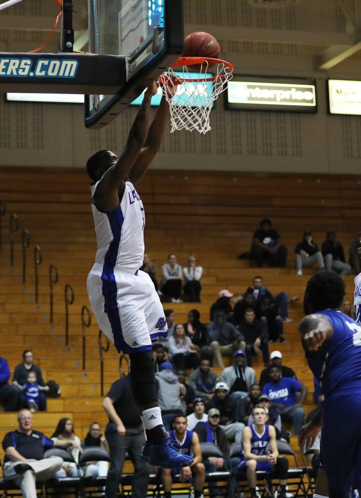 GVL/Kevin Sielaff - Trevin Alexander (5) goes up for a dunk during the game versus Great Lakes Christian on Wednesday, Nov. 16, 2016.