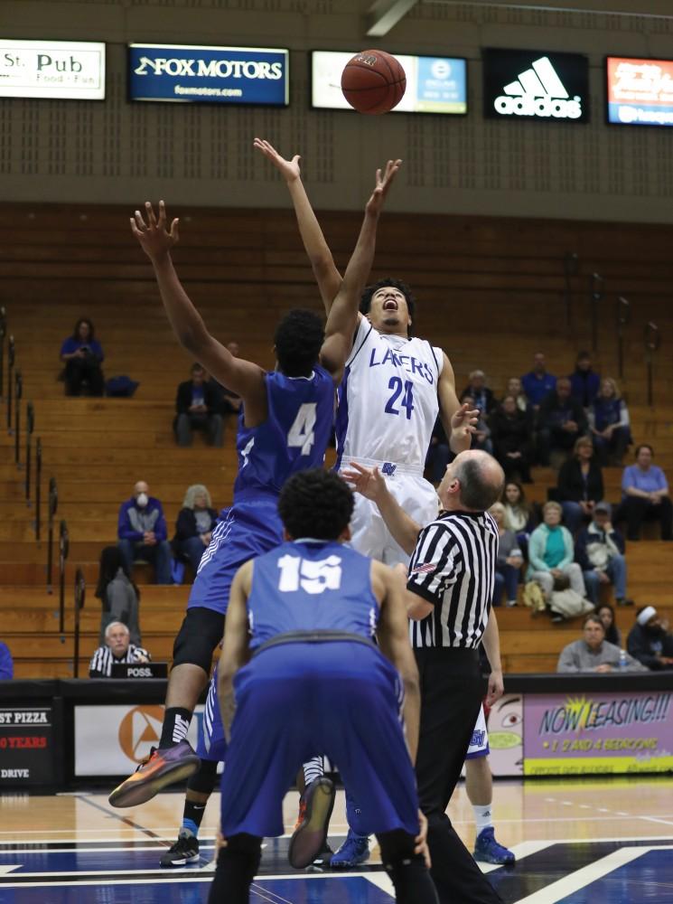 GVL/Kevin Sielaff - Justin Greason (24) jumps up for the tip-off during the game versus Great Lakes Christian on Wednesday, Nov. 16, 2016.