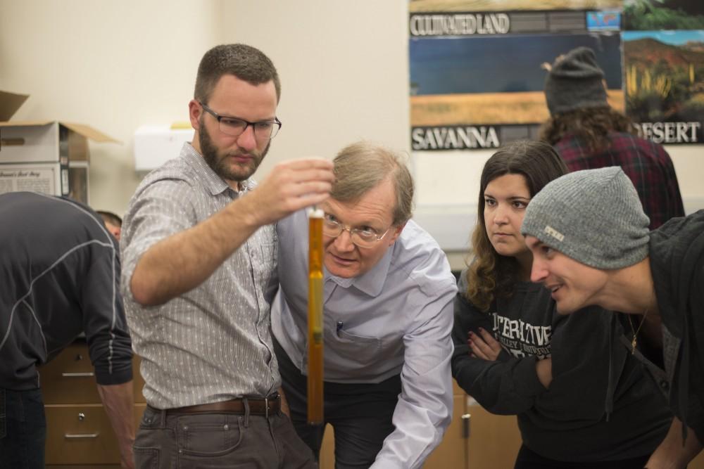 GVL / Luke Holmes - Biology professor, Mark Staves, helps his students with their brew in the Foundations of Brewing course. 