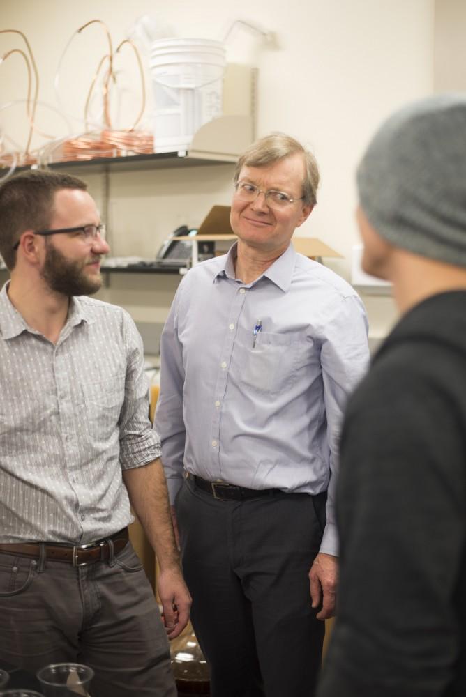 GVL / Luke Holmes - Biology professor, Mark Staves, helps his students with their brew in the Foundations of Brewing course. 