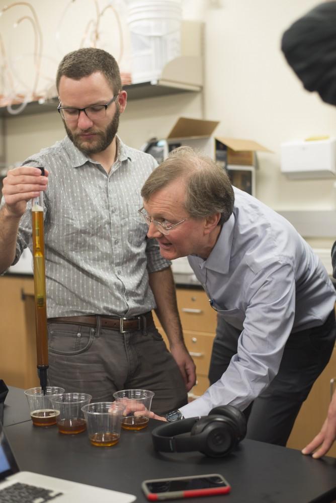 GVL / Luke Holmes - Biology professor, Mark Staves, helps a student with his brew in the Foundations of Brewing course. 