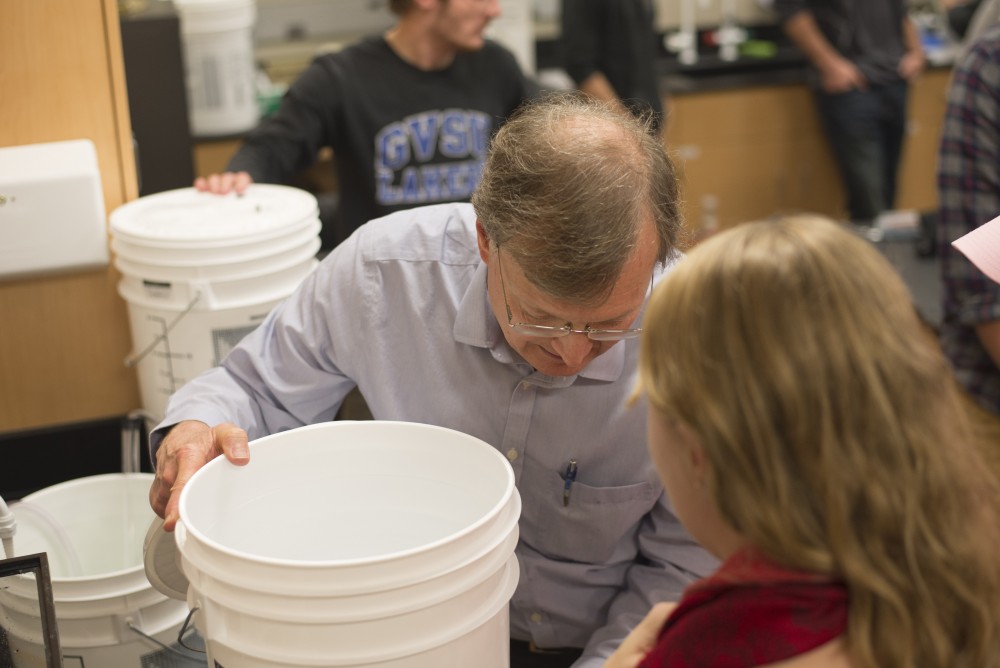 GVL / Luke Holmes - Biology professor, Mark Staves, helps his students with their brew in the Foundations of Brewing course. 