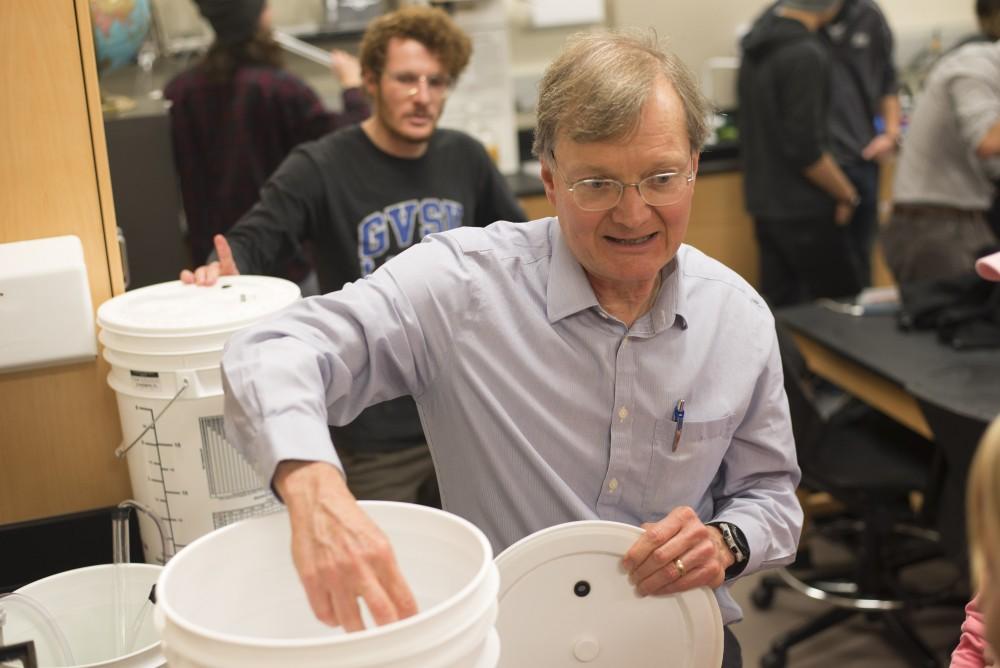 GVL / Luke Holmes - Biology professor, Mark Staves, helps his students with their brew in the Foundations of Brewing course. 