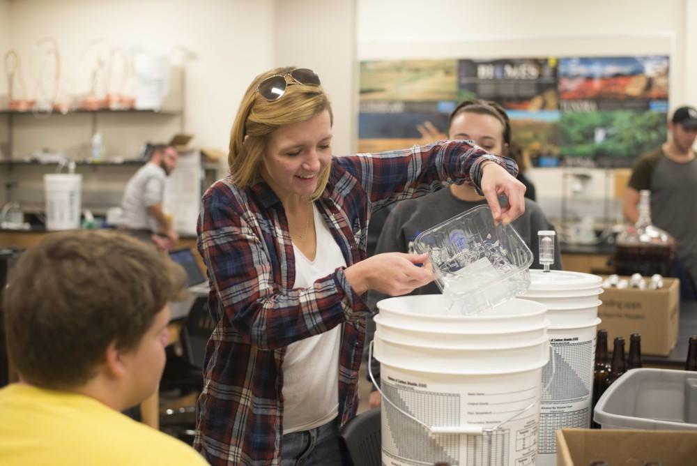 GVL / Luke Holmes - Natalie VanDorn works with her group on brewing their beer. Biology professor, Mark Staves, teaches the CMB 350 Foundations of Brewing course. 