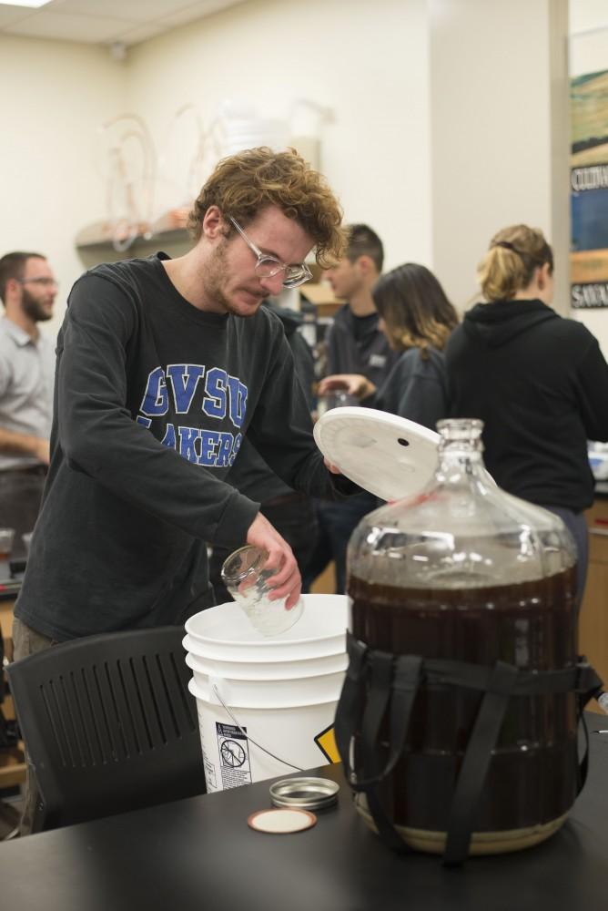 GVL / Luke Holmes - Zack Drescher works on his group's brew. Biology professor, Mark Staves, teaches the CMB 350 Foundations of Brewing course. 