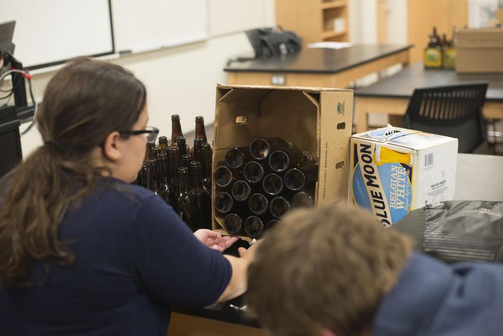 GVL / Luke Holmes - Students work on bottling the beer they brewed. Biology professor, Mark Staves, teaches the CMB 350 Foundations of Brewing course. 