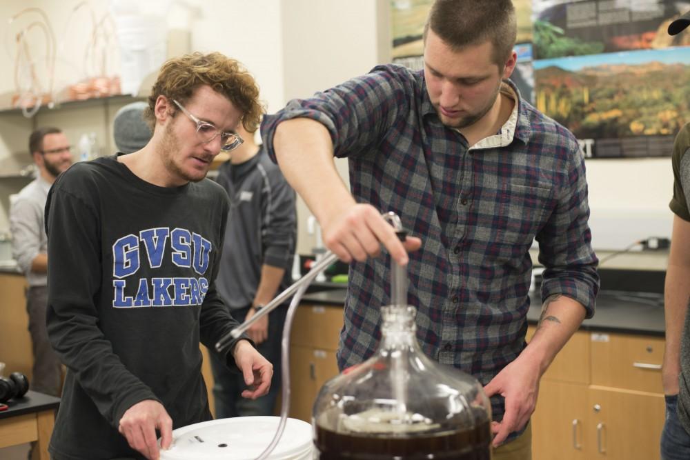 GVL / Luke Holmes - Zack Drescher (left) and Devon Schumaker (right) work on their brew. Biology professor, Mark Staves, teaches the CMB 350 Foundations of Brewing course. 